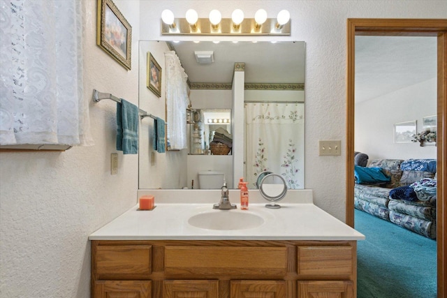 5057 Kasch Rd, Pecatonica, IL 61063 - full bathroom featuring a textured wall, vanity, ensuite bathroom, and toilet