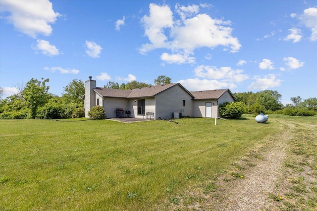 5057 Kasch Rd, Pecatonica, IL 61063 - view of side of property with a chimney, a patio area, a lawn, and cooling unit