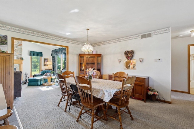 5057 Kasch Rd, Pecatonica, IL 61063 - dining room with light carpet, baseboards, and a chandelier