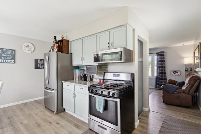 2383 Prairie Ave, Beloit, WI 53511 - kitchen with stainless steel appliances, light wood finished floors, open floor plan, and baseboards