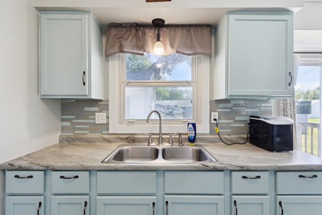 2383 Prairie Ave, Beloit, WI 53511 - kitchen featuring a sink, decorative backsplash, light countertops, and healthy amount of natural light