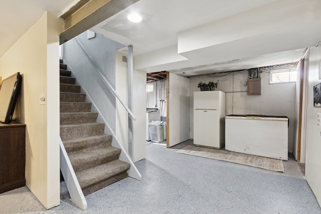 2383 Prairie Ave, Beloit, WI 53511 - below grade area with freestanding refrigerator, refrigerator, and stairs