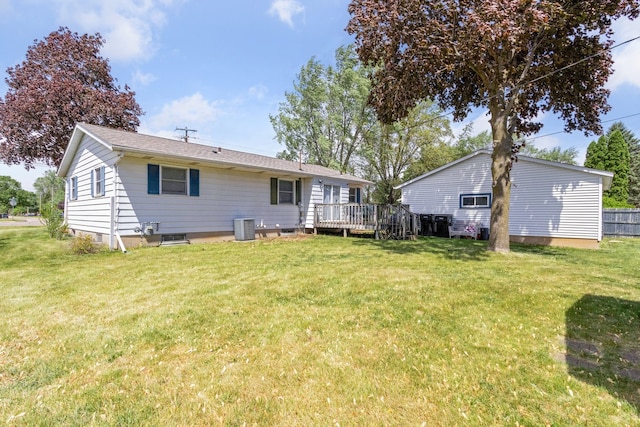 2383 Prairie Ave, Beloit, WI 53511 - rear view of house with central AC unit, a wooden deck, and a lawn