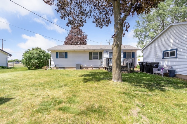 2383 Prairie Ave, Beloit, WI 53511 - rear view of house with a deck, a yard, and central AC