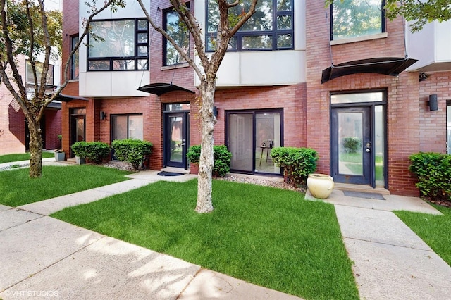 2330 W Armitage Ave Unit B, Chicago, IL 60647 - view of front of home featuring brick siding and a front lawn