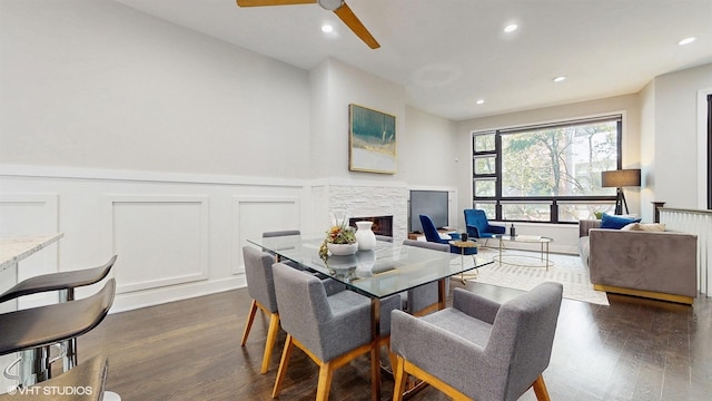 2330 W Armitage Ave Unit B, Chicago, IL 60647 - dining room featuring dark wood-style floors, a stone fireplace, a ceiling fan, wainscoting, and a decorative wall