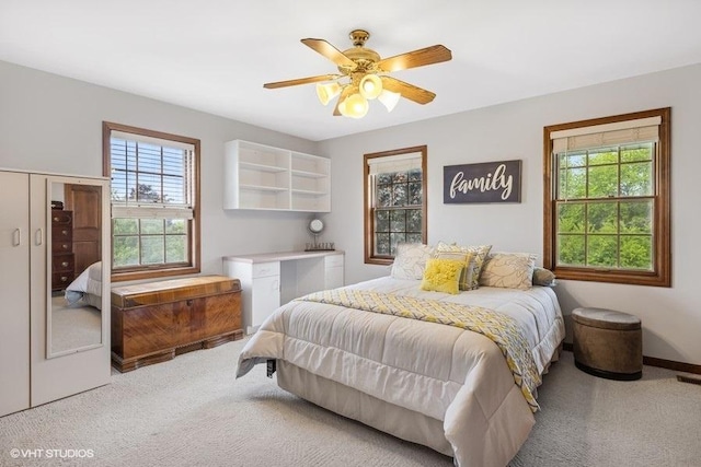 1302 Moraine Dr, Woodstock, IL 60098 - carpeted bedroom featuring multiple windows, a ceiling fan, and baseboards