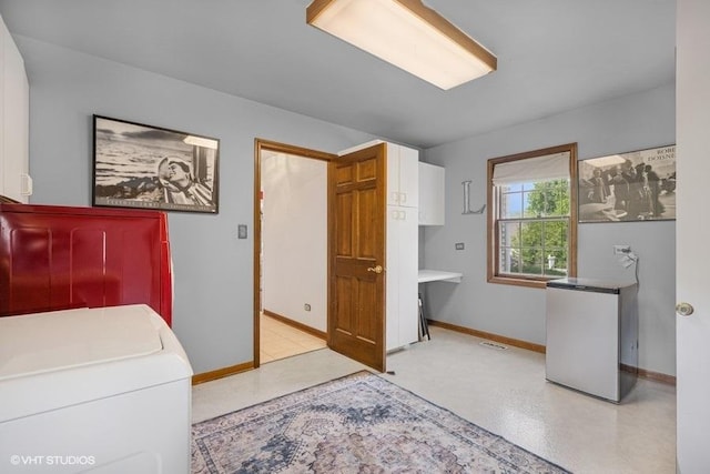 1302 Moraine Dr, Woodstock, IL 60098 - laundry room featuring cabinet space, washer / dryer, and baseboards