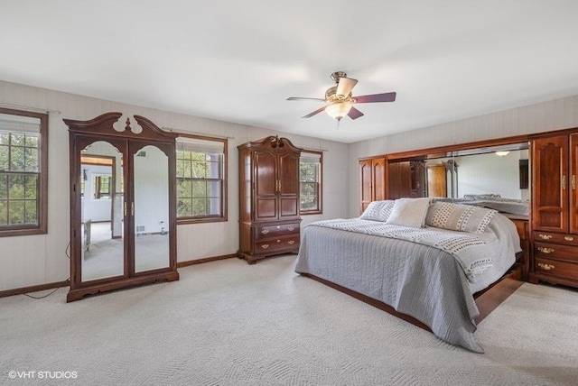 1302 Moraine Dr, Woodstock, IL 60098 - bedroom featuring multiple windows, baseboards, and light carpet