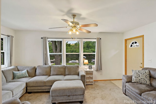24991 W Forest Dr, Lake Villa, IL 60046 - living area featuring plenty of natural light, a ceiling fan, light colored carpet, and baseboards