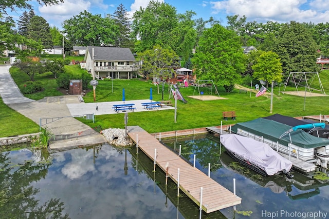 24991 W Forest Dr, Lake Villa, IL 60046 - dock featuring a playground, a lawn, and view of wooded area