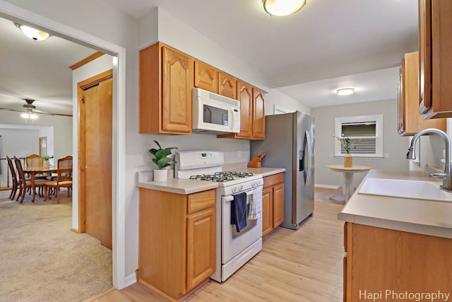 24991 W Forest Dr, Lake Villa, IL 60046 - kitchen featuring white appliances, a sink, ceiling fan, light wood-style floors, and light countertops