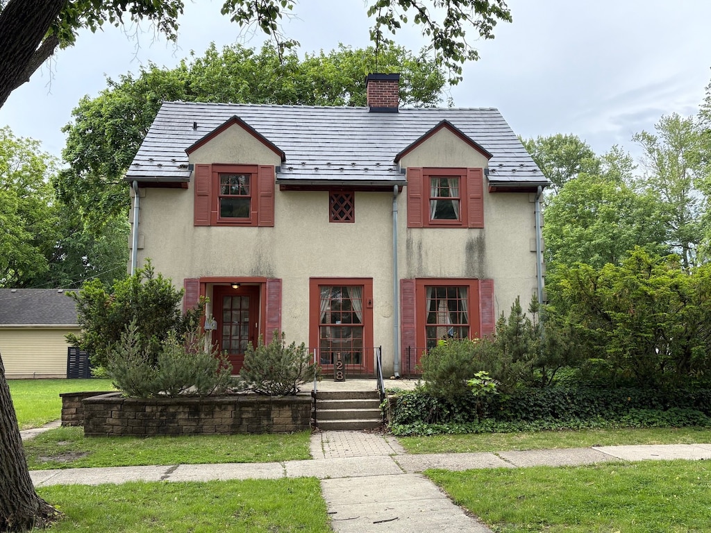128 W 8th Ave, Naperville, IL 60563 - view of front facade with stucco siding, a chimney, a front yard, and a porch