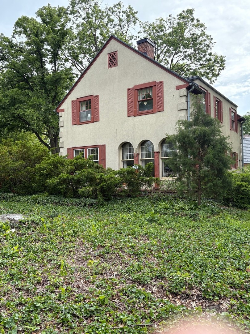 128 W 8th Ave, Naperville, IL 60563 - view of front of property with a chimney and stucco siding