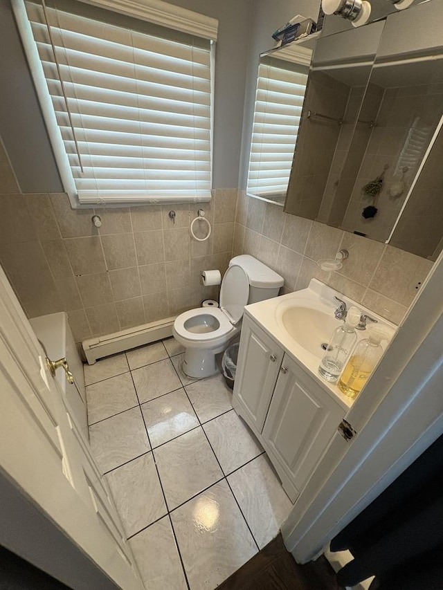 7070 N Ridge Blvd Unit 1B, Chicago, IL 60645 - bathroom featuring tile walls, a baseboard heating unit, a shower stall, vanity, and tile patterned flooring