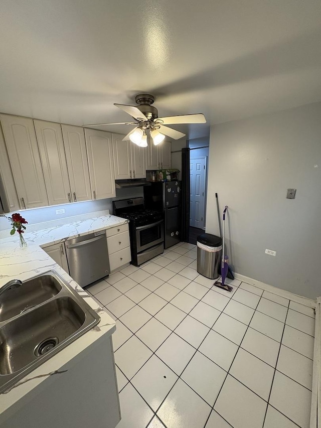 7070 N Ridge Blvd Unit 1B, Chicago, IL 60645 - kitchen featuring stainless steel appliances, ceiling fan, light tile patterned floors, a sink, and white cabinetry