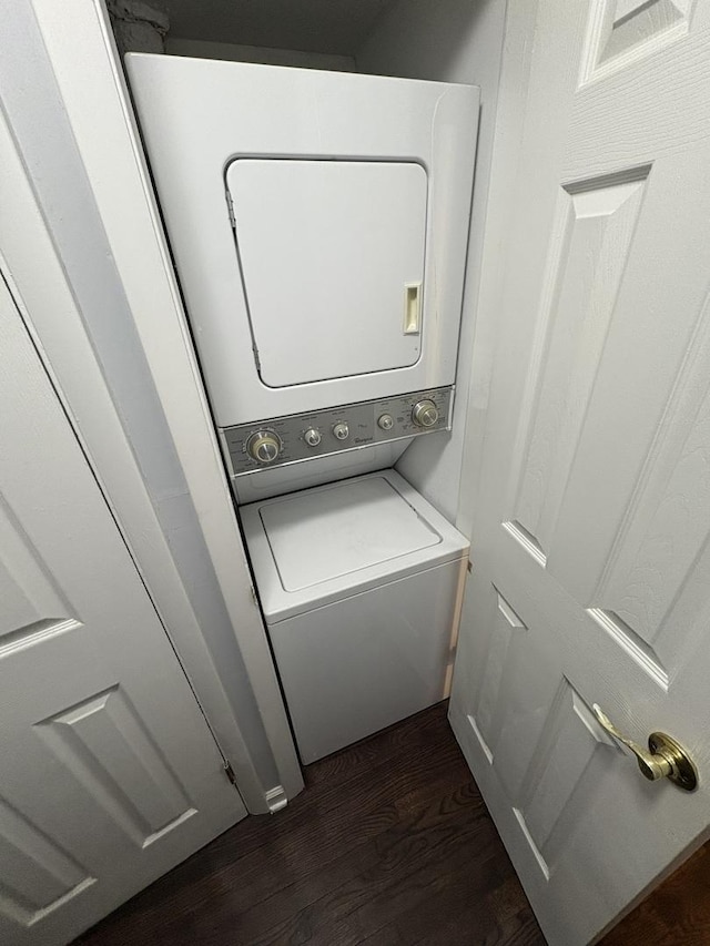 7070 N Ridge Blvd Unit 1B, Chicago, IL 60645 - laundry area with stacked washer / drying machine and dark wood-type flooring