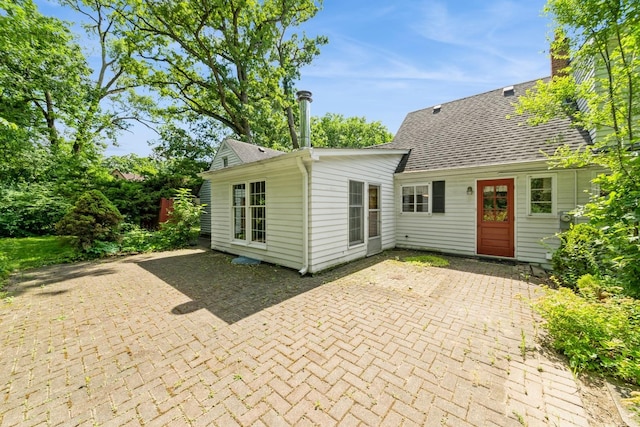 4N051 Wood Dale Rd, Addison, IL 60101 - rear view of house with a patio and roof with shingles