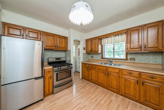 4N051 Wood Dale Rd, Addison, IL 60101 - kitchen featuring stainless steel appliances, brown cabinets, light countertops, and light wood-type flooring