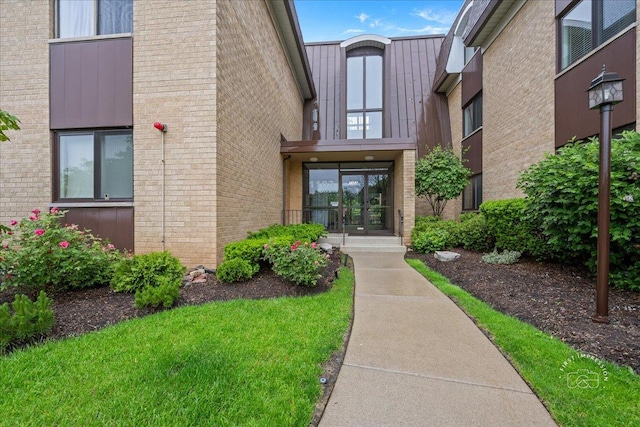 1103 N Mill St Unit 111, Naperville, IL 60563 - view of exterior entry featuring french doors and brick siding