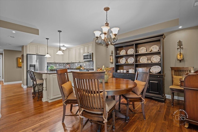1103 N Mill St Unit 111, Naperville, IL 60563 - dining room featuring wood finished floors, a chandelier, baseboards, and recessed lighting