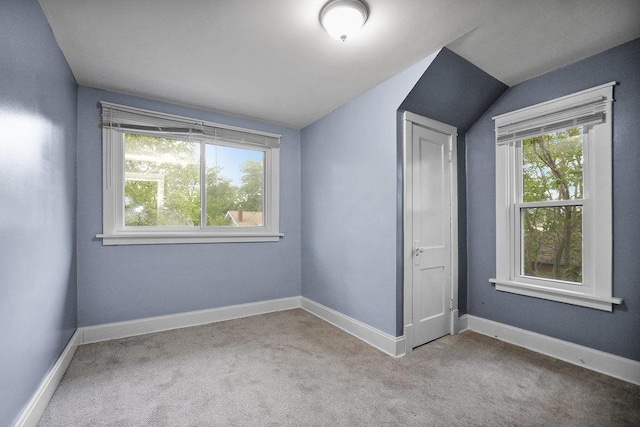8 Manor Ct, Joliet, IL 60436 - unfurnished bedroom with multiple windows, carpet flooring, vaulted ceiling, and baseboards