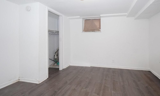 8 Manor Ct, Joliet, IL 60436 - below grade area with dark wood-style flooring and baseboards