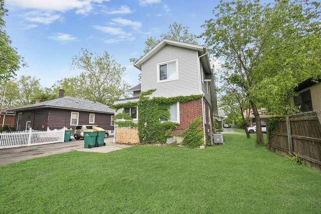 8 Manor Ct, Joliet, IL 60436 - rear view of property featuring central AC unit, a patio, brick siding, and a chimney