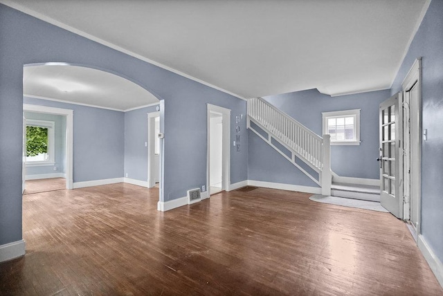 8 Manor Ct, Joliet, IL 60436 - unfurnished living room featuring arched walkways, wood finished floors, baseboards, crown molding, and stairway