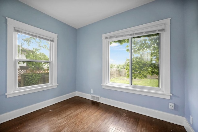 8 Manor Ct, Joliet, IL 60436 - empty room featuring healthy amount of natural light, dark wood-style floors, and baseboards