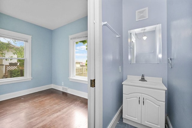 8 Manor Ct, Joliet, IL 60436 - bathroom with vanity, wood finished floors, and baseboards