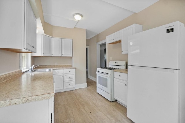 8 Manor Ct, Joliet, IL 60436 - kitchen with white appliances, a sink, white cabinetry, and light countertops