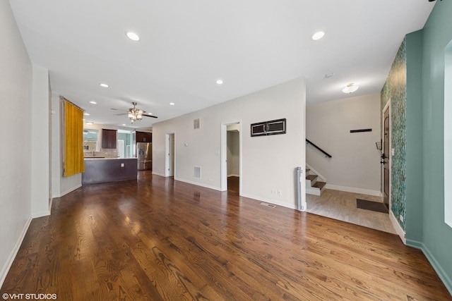 1933 W 22nd Pl, Chicago, IL 60608 - unfurnished living room with recessed lighting, stairs, dark wood-style floors, and ceiling fan