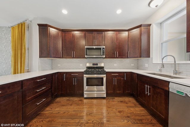 1933 W 22nd Pl, Chicago, IL 60608 - kitchen featuring appliances with stainless steel finishes, dark wood-style flooring, backsplash, light countertops, and recessed lighting