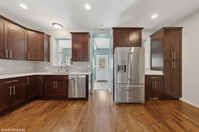 1933 W 22nd Pl, Chicago, IL 60608 - kitchen with appliances with stainless steel finishes, dark wood-style flooring, light countertops, decorative backsplash, and recessed lighting