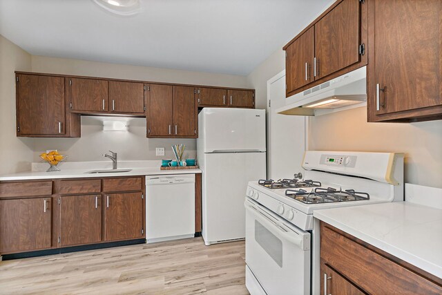 218 Deerpath Ct Unit B2, Schaumburg, IL 60193 - kitchen with white appliances, under cabinet range hood, a sink, light countertops, and light wood-type flooring