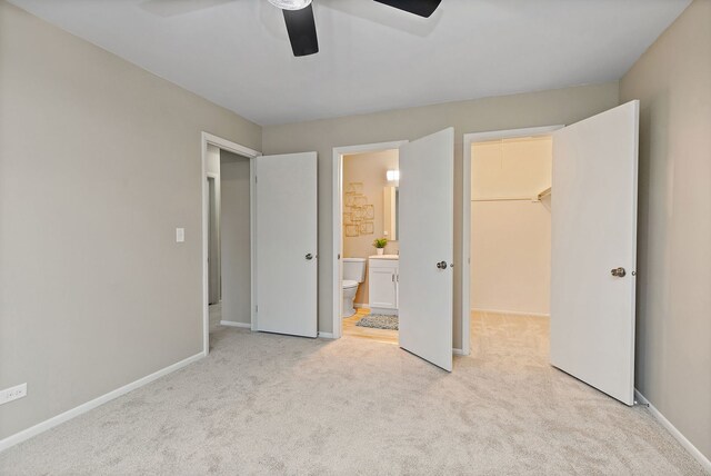 218 Deerpath Ct Unit B2, Schaumburg, IL 60193 - unfurnished bedroom with light colored carpet, a spacious closet, baseboards, ensuite bath, and ceiling fan