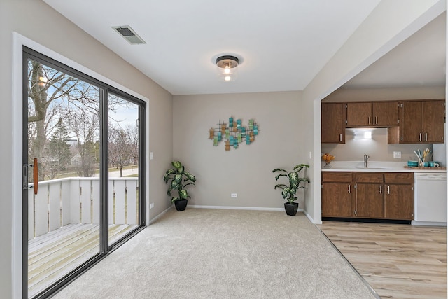 218 Deerpath Ct Unit B2, Schaumburg, IL 60193 - kitchen featuring white dishwasher, light countertops, a sink, and baseboards