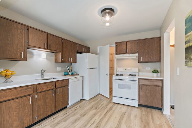218 Deerpath Ct Unit B2, Schaumburg, IL 60193 - kitchen with white appliances, under cabinet range hood, a sink, light wood-style floors, and light countertops