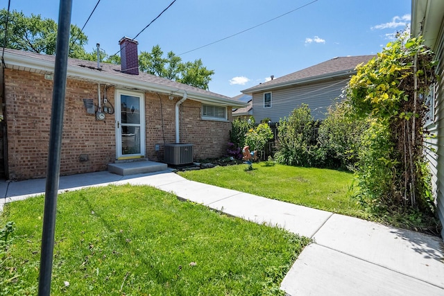 5708 W 82nd Pl, Burbank, IL 60459 - view of front of home featuring a front yard, central AC unit, a chimney, and brick siding