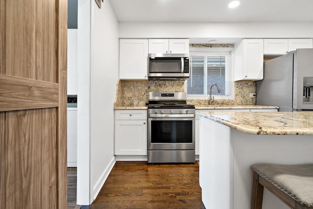 5708 W 82nd Pl, Burbank, IL 60459 - kitchen with appliances with stainless steel finishes, dark wood-style flooring, light stone counters, tasteful backsplash, and white cabinets