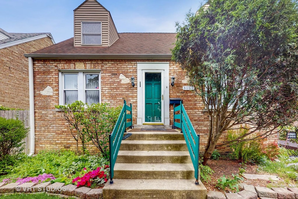 3109 Emerson St, Franklin Park, IL 60131 - doorway to property featuring brick siding and a shingled roof