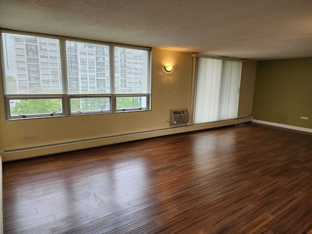 8815 W Golf Rd Unit 6B, Niles, IL 60714 - spare room featuring a textured ceiling, wood finished floors, a baseboard heating unit, and a wall mounted AC