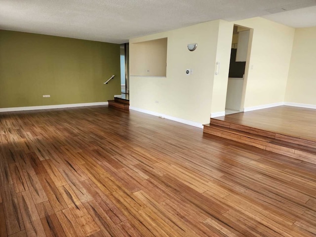 8815 W Golf Rd Unit 6B, Niles, IL 60714 - empty room with wood finished floors, baseboards, and a textured ceiling