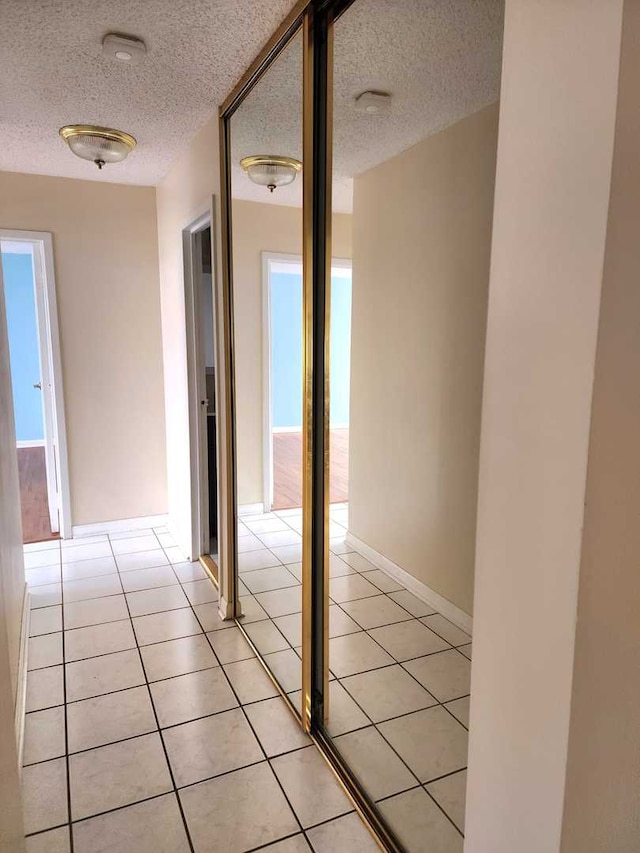 8815 W Golf Rd Unit 6B, Niles, IL 60714 - hall with a textured ceiling and light tile patterned floors