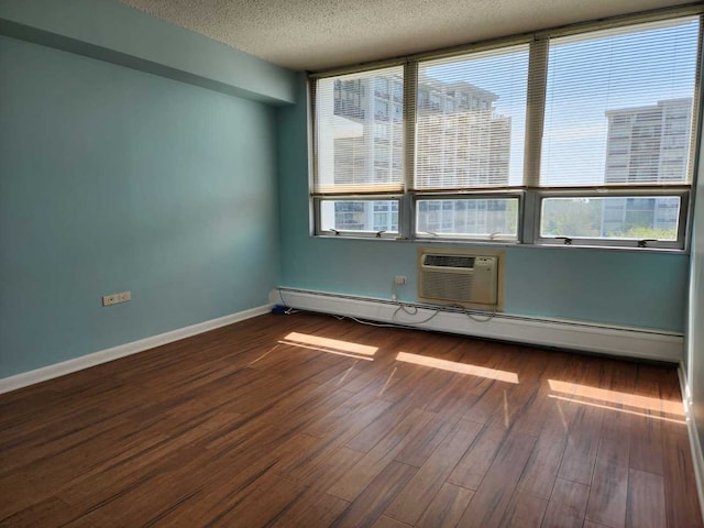 8815 W Golf Rd Unit 6B, Niles, IL 60714 - empty room featuring healthy amount of natural light, a textured ceiling, dark wood-type flooring, baseboards, and a baseboard heating unit