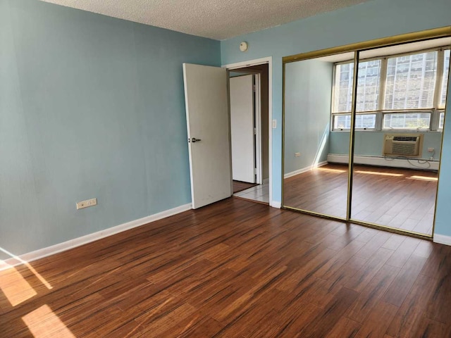 8815 W Golf Rd Unit 6B, Niles, IL 60714 - unfurnished bedroom with wood finished floors, a baseboard heating unit, a closet, a textured ceiling, and baseboards