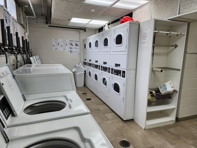 8815 W Golf Rd Unit 6B, Niles, IL 60714 - shared laundry featuring stacked washer / dryer, washing machine and clothes dryer, and concrete block wall