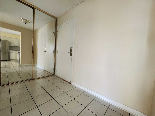 8815 W Golf Rd Unit 6B, Niles, IL 60714 - unfurnished room featuring light tile patterned floors and baseboards