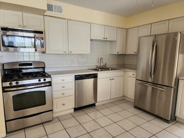 8815 W Golf Rd Unit 6B, Niles, IL 60714 - kitchen with appliances with stainless steel finishes, a sink, light countertops, tasteful backsplash, and white cabinets
